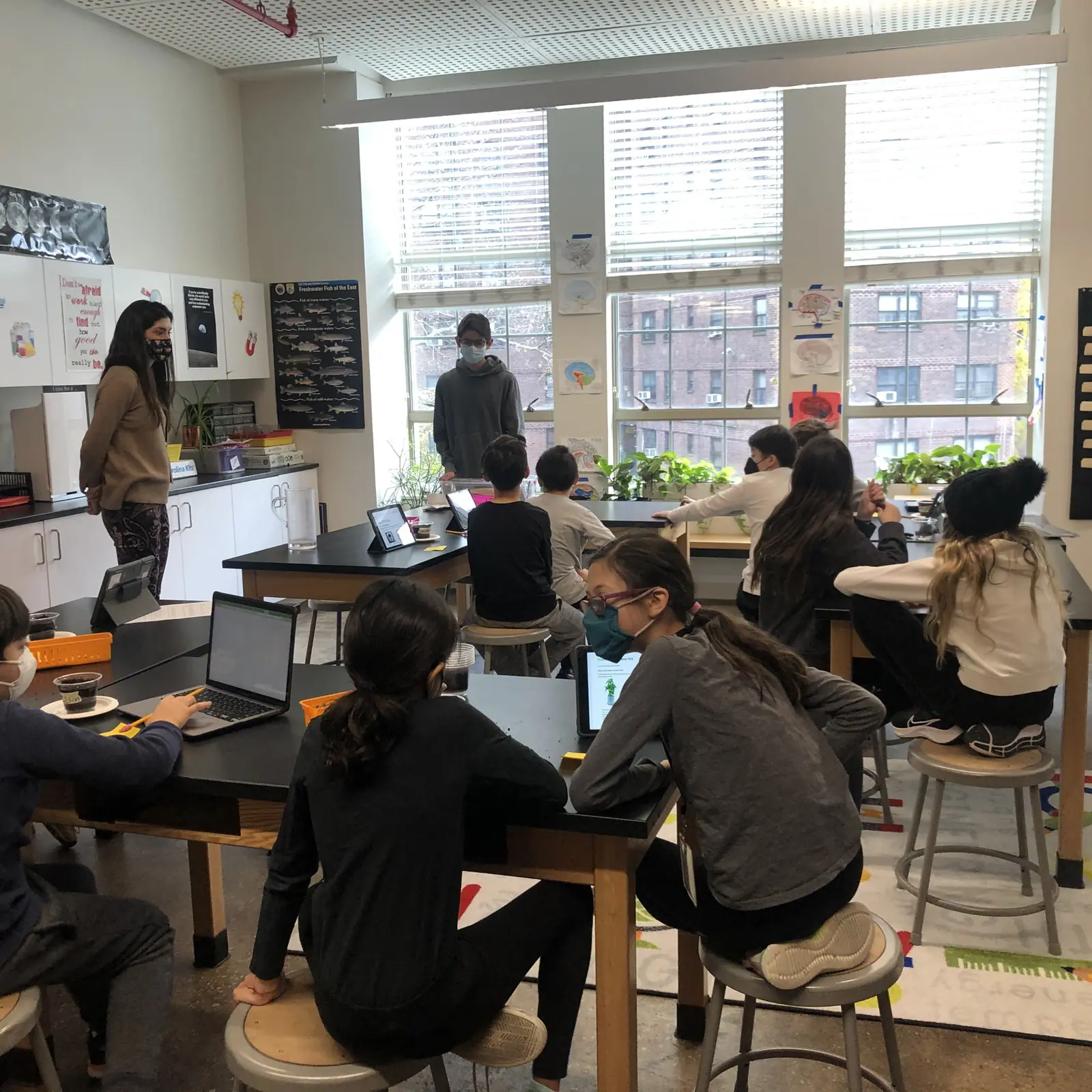 Two MintBox members presenting a Baby Sprout EDU kit to a 5th grade class.