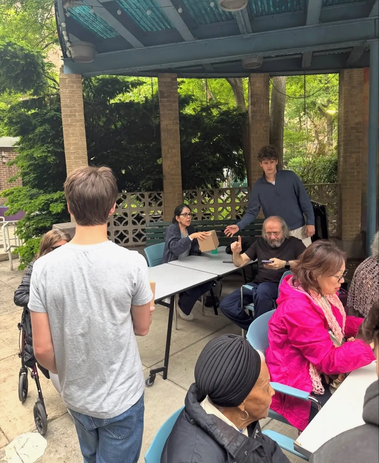 Members and residents under the courtyard pergola.