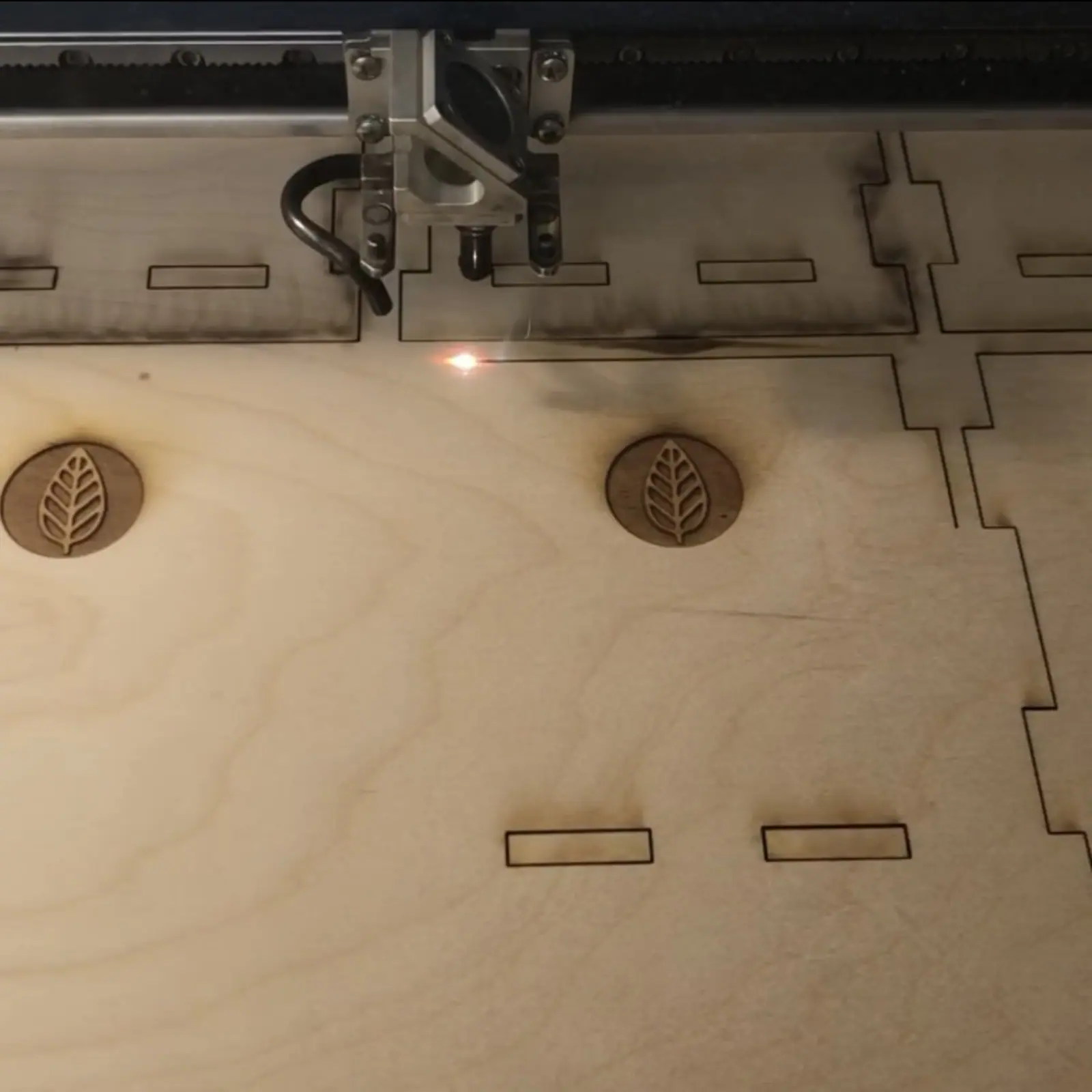 A laser cutter partway through cutting the flat panels of a Baby Sprout chassis.