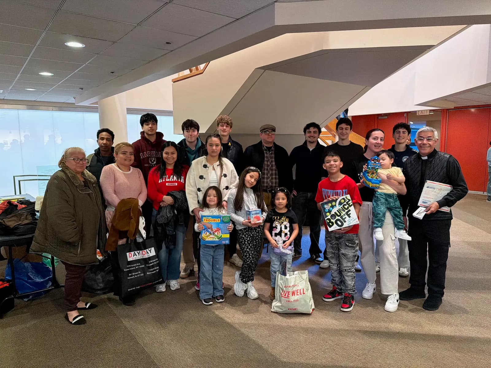 Volunteers, families and community members gathered for a group photo at the MintBox Community Giveaway.