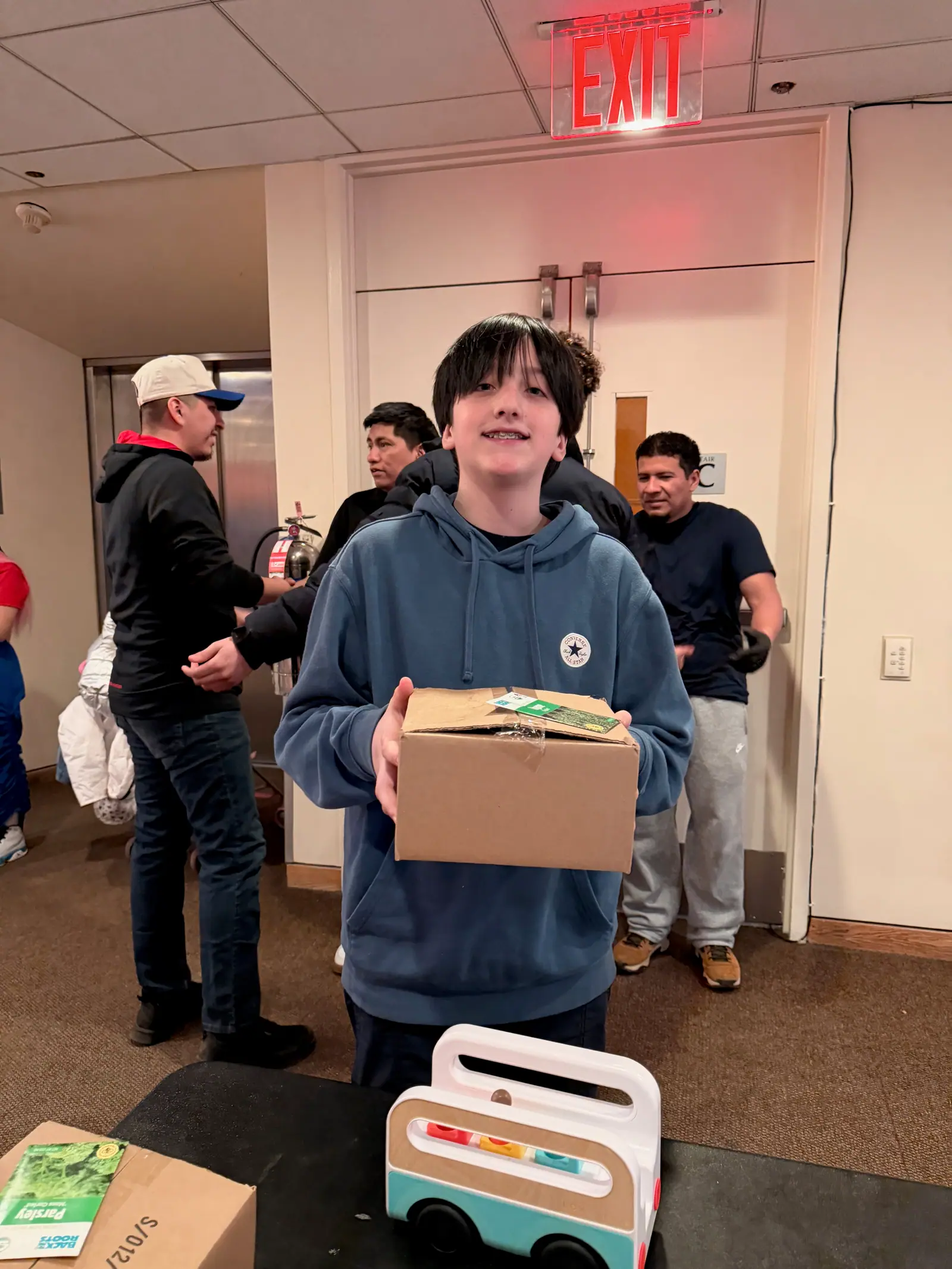 A smiling teenager with his MintBox.
